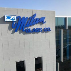 Blue Milan Glass Sign on side of building