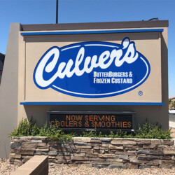 beige, blue and white Culver's Sign on Stone foundation next to street